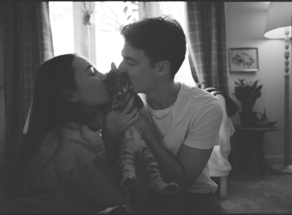 couple kissing cat on film