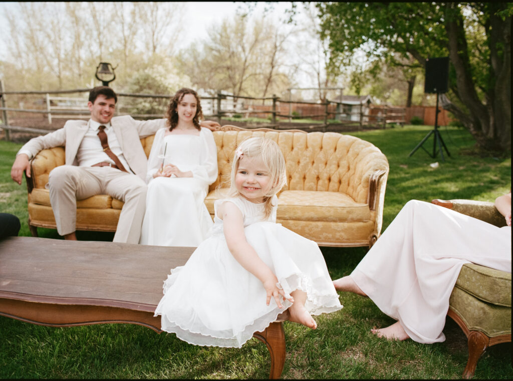candid photo of flower girl at a backyard wedding