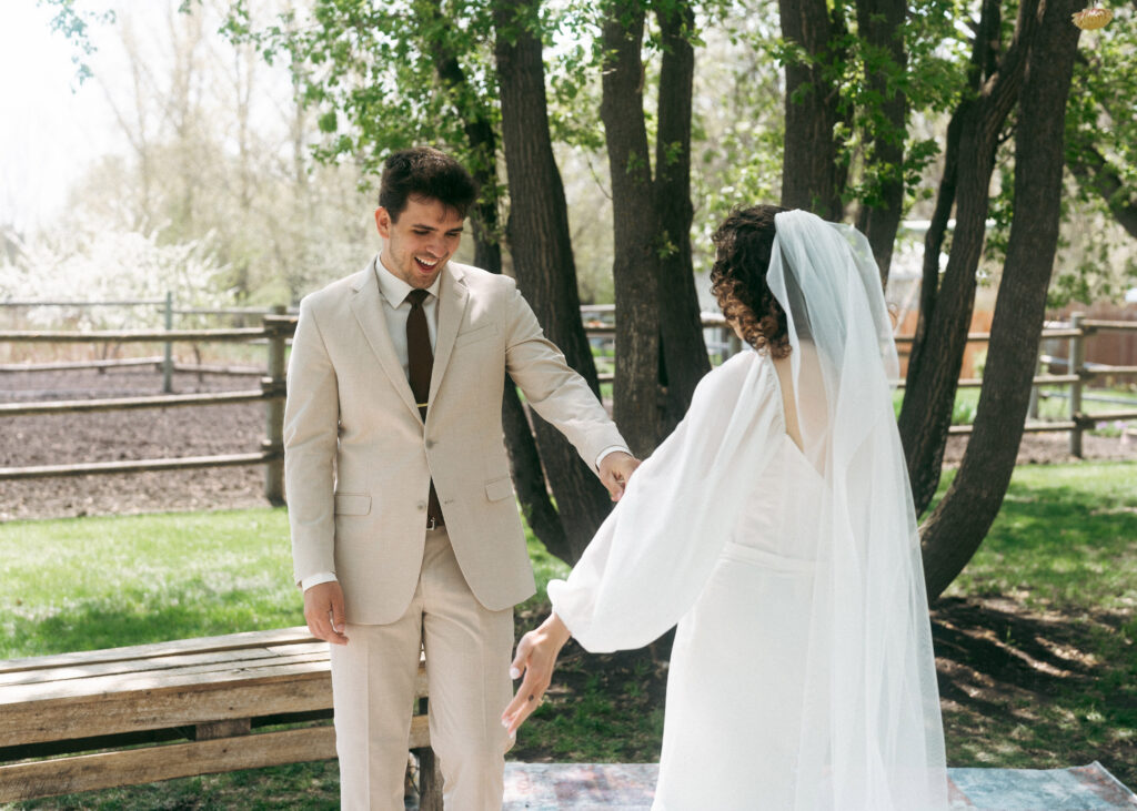bride and groom first look in backyard wedding