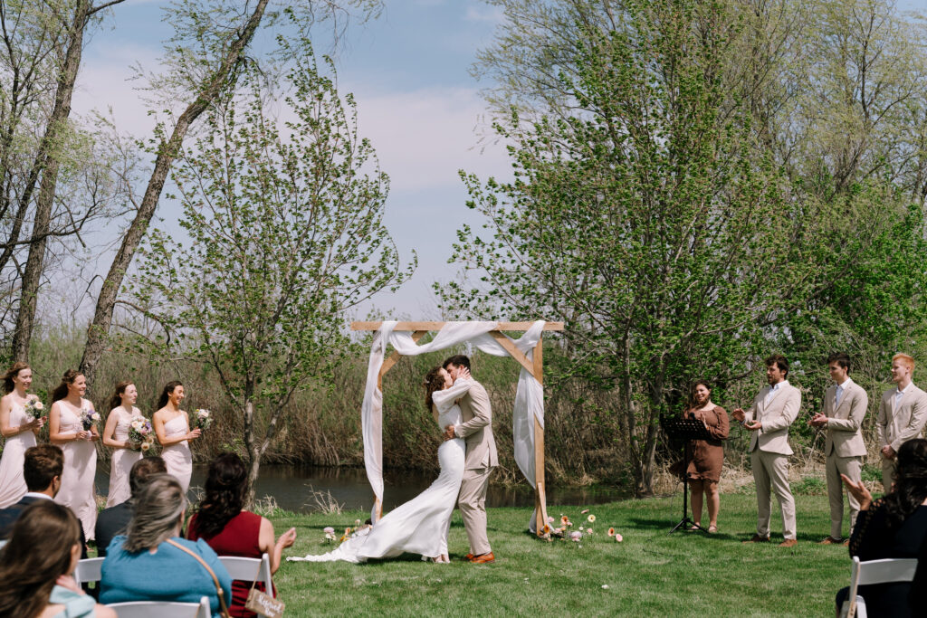 First kiss in backyard wedding cermemony