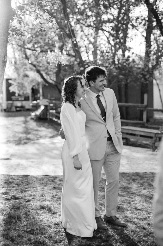 black and white candid photo of bride and groom