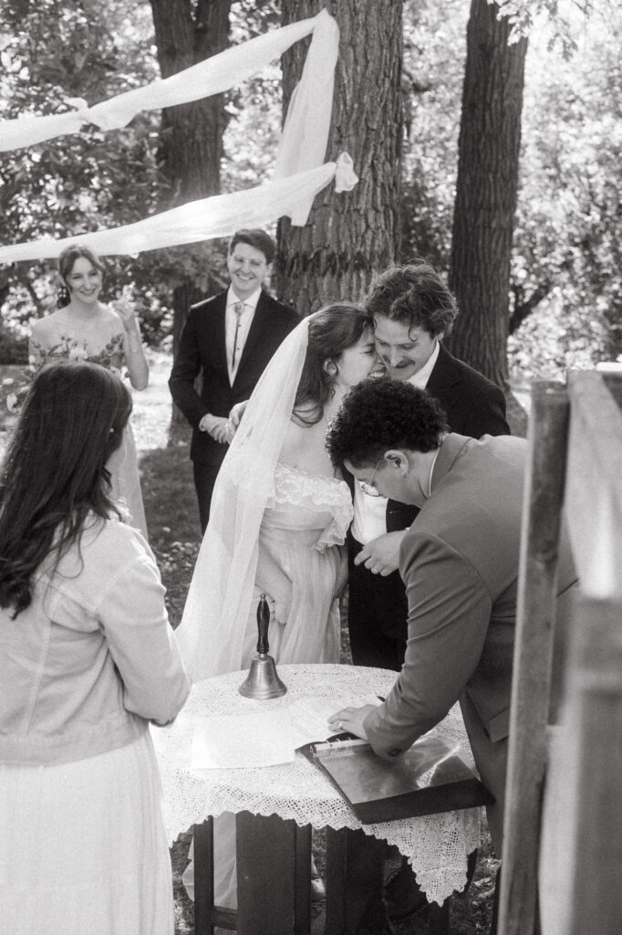candid documentary-style wedding photography of bride and groom signing papers