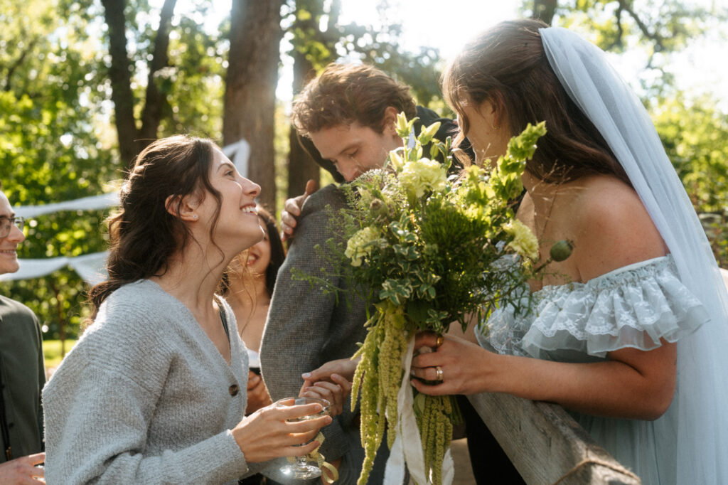 Bride and groom with guests. Documentary-style candid.