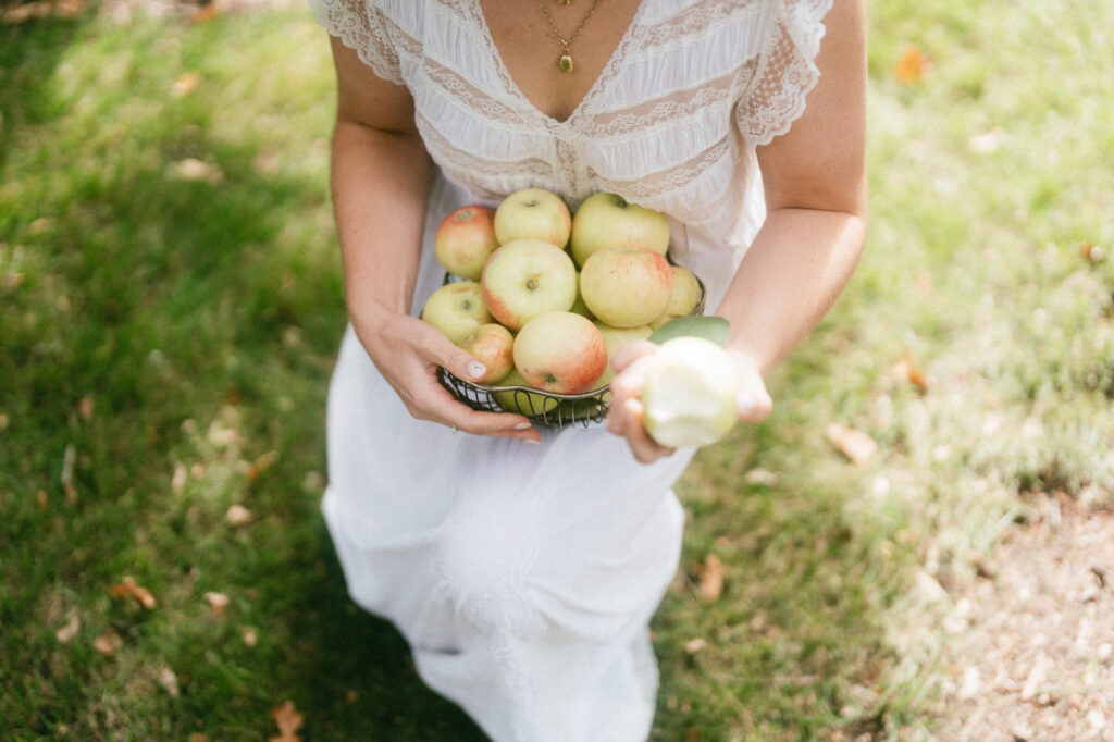 documentary-style wedding photo of bride holding apple