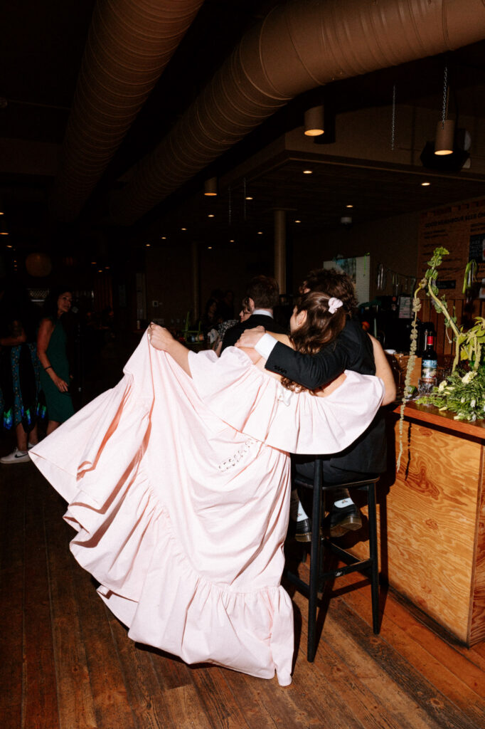 documentary-style photo at wedding reception of bride and groom