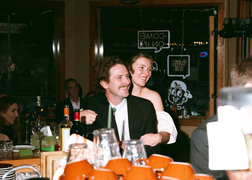 documentary-style photo at wedding reception of bride and groom