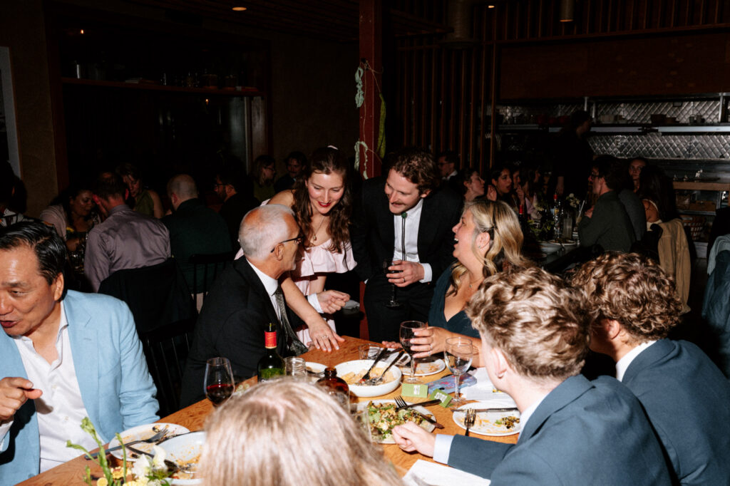 documentary-style photo at wedding reception of bride and groom