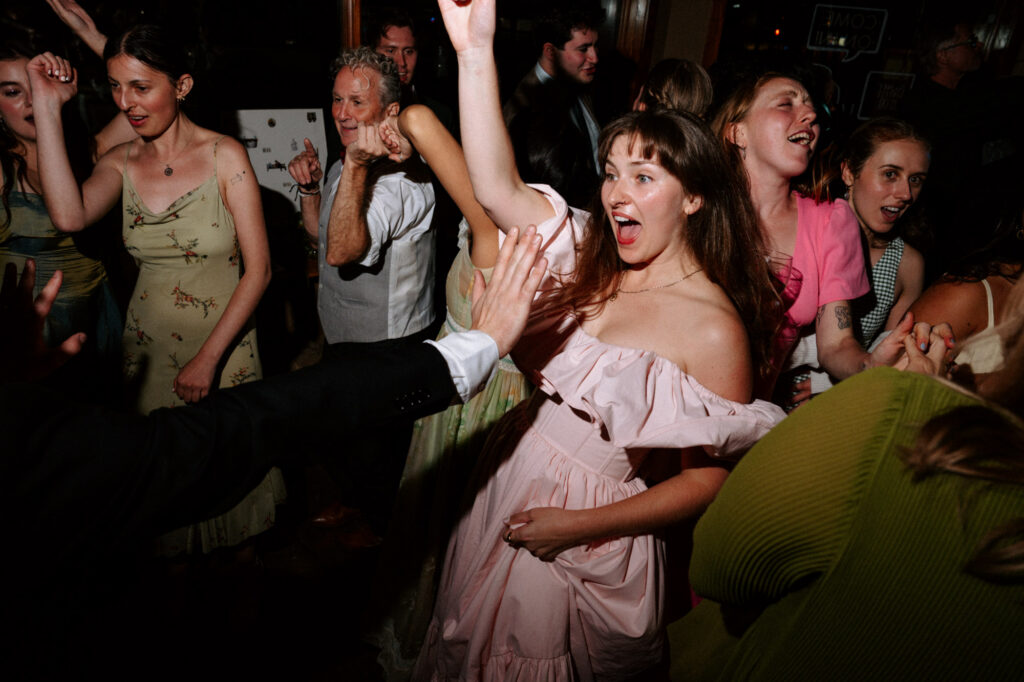 documentary style wedding photo of guests dancing