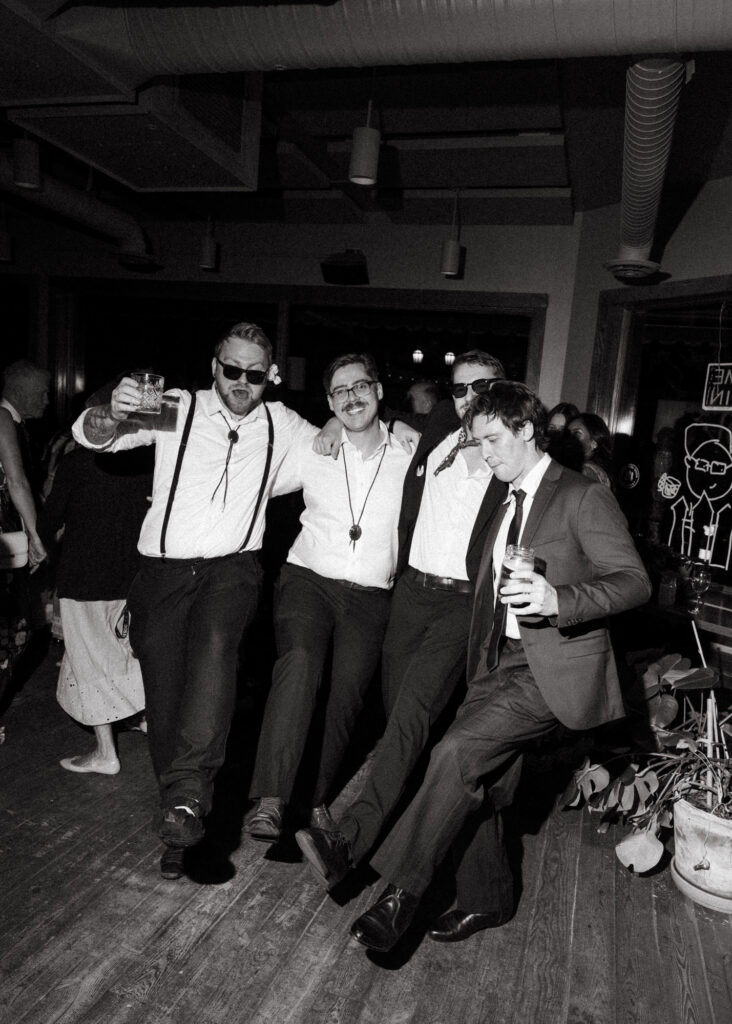 documentary style wedding photo of guests dancing
