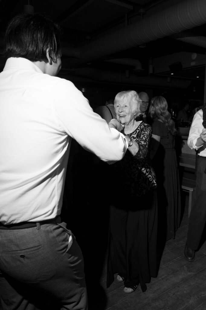 documentary style wedding photo of guests dancing