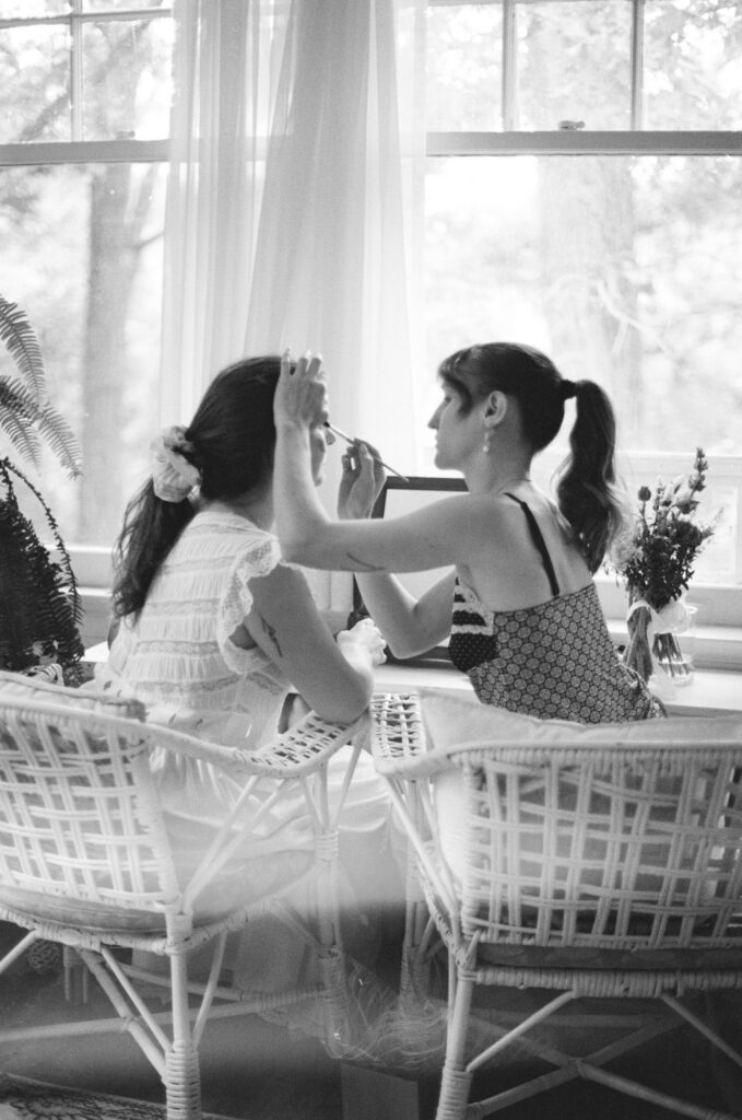 documentary-style photo of bride getting ready with sister
