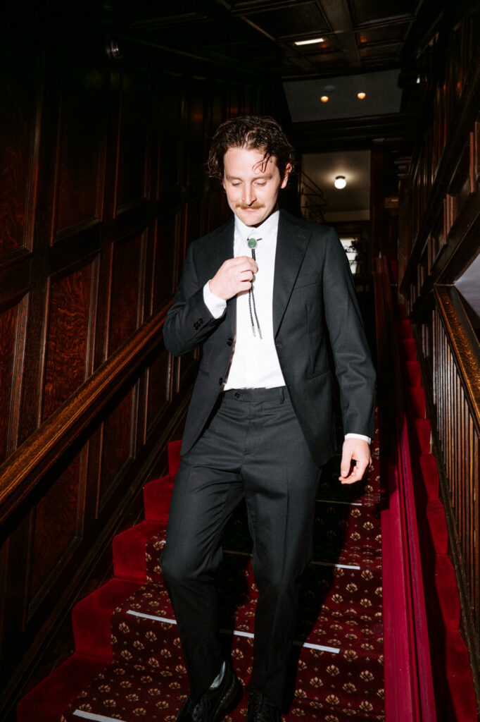 editorial-style photo of groom on wedding day