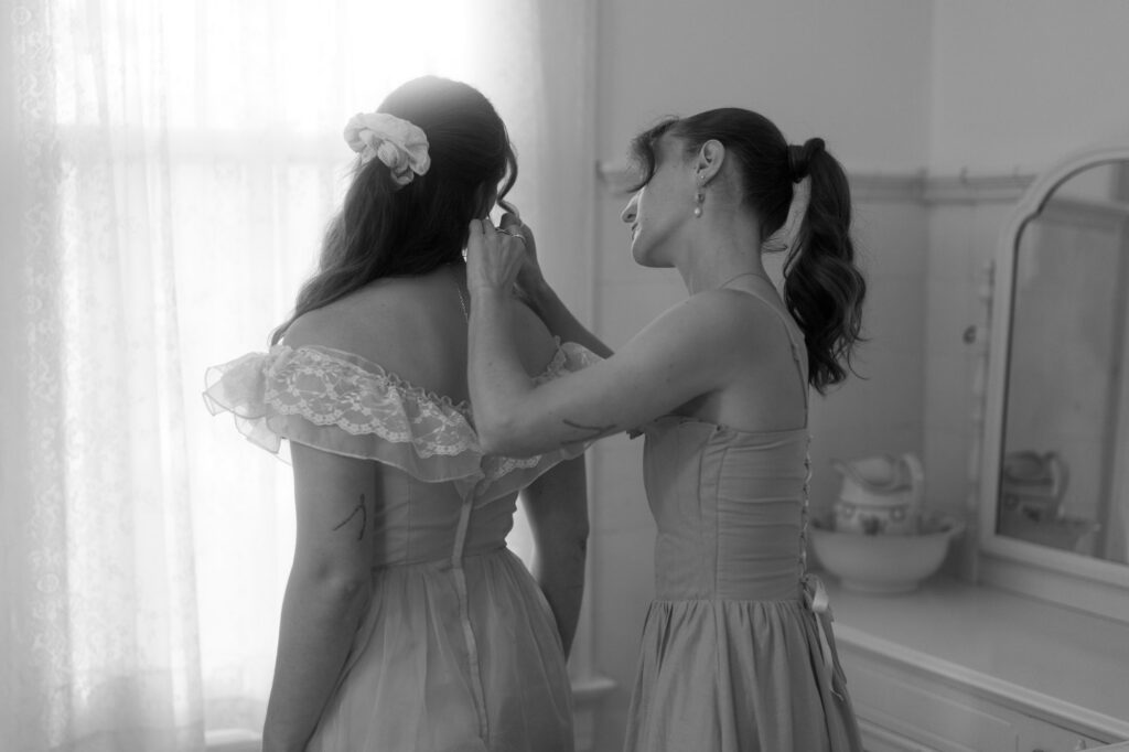 documentary-style photo of bride getting ready with sister