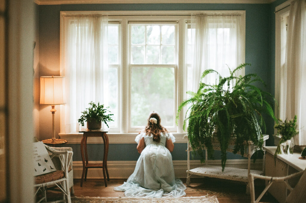 Bride looking out the window at her wedding